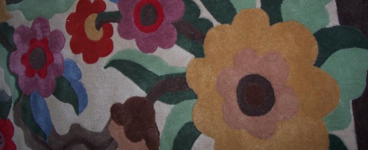 Close-up of 100% acrylic carpet pile showing hand-crafted floral detail